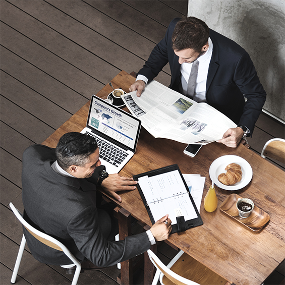 An image showing two businessmen working